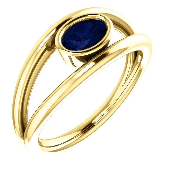 14KT GOLD 0.70 CARAT OVAL BEZEL SET SAPPHIRE RING